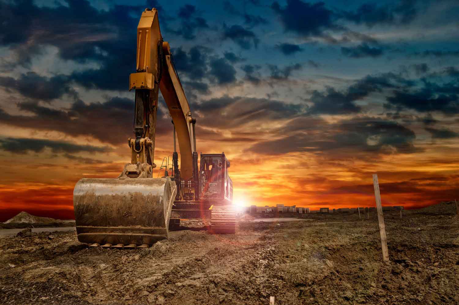 Excavating,Machinery,At,The,Construction,Site,,Sunset,In,Background.